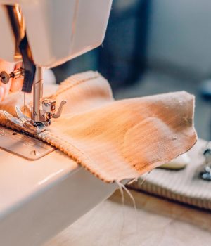 female-hands-stitching-fabric-on-machine-free-photo